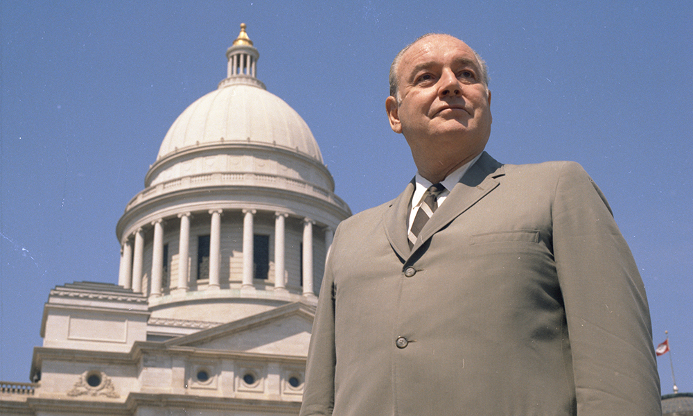 winthrop rockefeller standing in front of the arkansas state capitol building