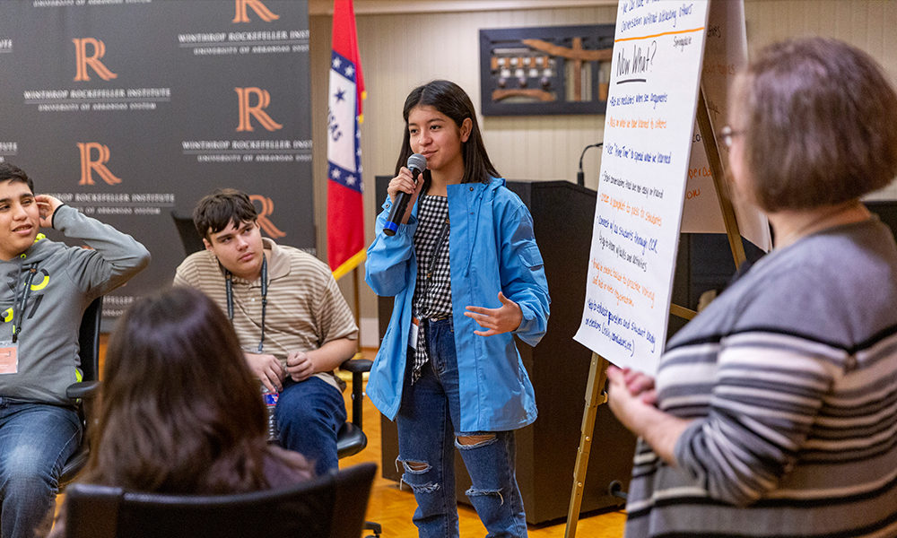 a high school student leads a group brainstorming session at the Winthrop Rockefeller Institute